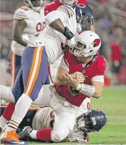  ??  ?? Defensive end Jonathan Bullard and linebacker Sam Acho ( left) bring down Cardinals backup QB Drew Stanton in the second quarter. | AP