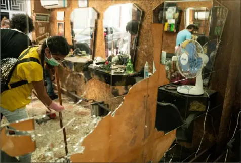  ?? Manu Ferneini/The Washington Post ?? Volunteers help clean up the debris Monday at Salon Georges, a heavily damaged barbershop in Beirut.