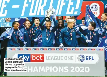  ??  ?? Champion feeling: Captain Liam Kelly lifts the League One trophy as the Sky Blues squad celebrate