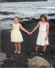  ?? COURTESY OF REX CRUM ?? The author’s daughters meet some of the residents of the Punaluu Black Sand Beach on Hawaii’s Big Island.