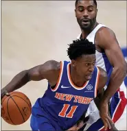  ?? CARLOS OSORIO — THE ASSOCIATED PRESS ?? New York Knicks’ Frank Ntilikina, left, drives around Detroit Pistons’ Wayne Ellington during Detroit’s loss on Friday.