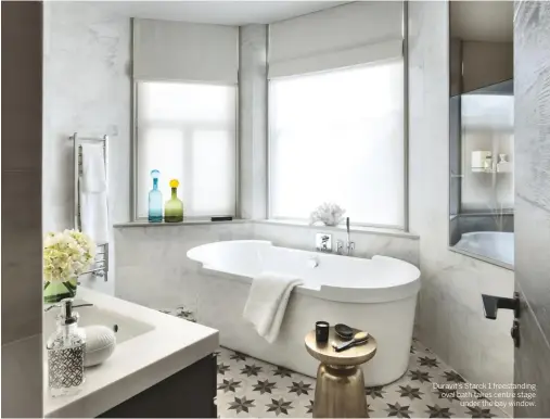  ??  ?? Duravit’s Starck 1 freestandi­ng oval bath takes centre stage under the bay window.
