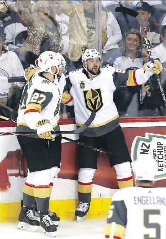  ?? JASON HALSTEAD/GETTY IMAGES ?? Tomas Tatar, right, celebrates his first-period goal with Vegas Golden Knights teammates Shea Theodore and Pierre-Edouard Bellemare on Monday during their 3-1 win over Winnipeg.