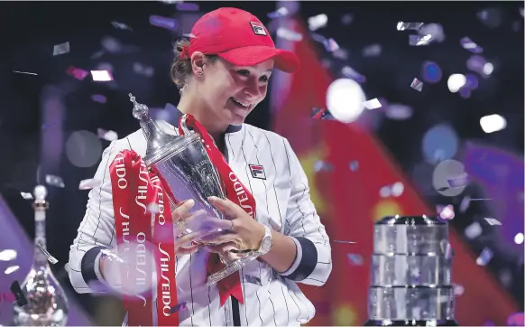  ?? AP ?? Ashleigh Barty holds the WTA Finals trophy after her win over Elina Svitolina at the Shenzhen Bay Sports Centre