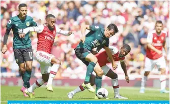  ??  ?? LONDON: Burnley’s English midfielder Jack Cork (C) vies with Arsenal’s English midfielder Ainsley Maitland-Niles (2nd R) and Arsenal’s French striker Alexandre Lacazette (2nd L) during the English Premier League football match between Arsenal and Burnley at the Emirates Stadium in London yesterday. — AFP