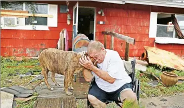  ?? JOE RAEDLE/GETTY IMAGES/AFP ?? Steve Culver cries with his dog Otis after what he said was the ‘most terrifying event in his life’, when Hurricane Harvey destroyed most of his home, on Saturday in Rockport, Texas.