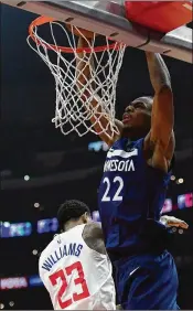  ?? HARRY HOW / GETTY IMAGES ?? The Timberwolv­es would like to unload Andrew Wiggins (dunking over Lou Williams of the Clippers) and his $146.5 million in pay in the next five years.