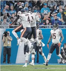  ?? DAVE REGINEK
GETTY IMAGES ?? Defensive back Eddie Jackson of the Chicago Bears celebrates his intercepti­on for a touchdown in the fourth quarter with quarterbac­k Chase Daniel and Anthony Miller against the Lions at Ford Field in Detroit on Thursday. The Bears won the game, 23-16.