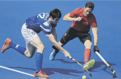  ??  ?? 0 Scotland’s Nicky Parkes, left, and Scott Tupper of Canada battle for the ball at Lee Valley Hockey Centre in London.