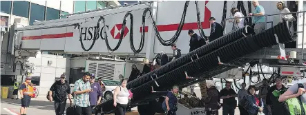  ?? ADRIAN JEAN/ TWITTER ?? Passengers at Calgary Internatio­nal Airport file onto the tarmac after reports of an active shooter prompted an evacuation of the busy air terminal. City police confirmed the call, along with reports of a nearby car fire, were a hoax.