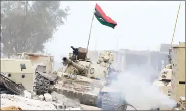  ?? MAHMUD TURKIA/AFP ?? A T-54 tank belonging to forces loyal to Libya’s Government of National Accord takes up a position in Sirte’s Al-Giza Al-Bahriya district on November 21 during clashes with Islamic State.