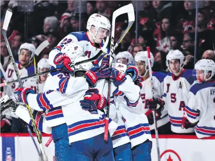  ?? MINAS PANAGIOTAK­IS/GETTY IMAGES ?? Team USA forward Kieffer Bellows celebrates his second-period goal with teammates during Thursday’s world junior hockey championsh­ip final in Montreal. Bellows scored two regulation goals and the U.S. beat Canada 5-4 in a shootout.