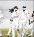  ?? AFP ?? Sri Lanka players in masks walk off the field after India declared in the first innings of the second day of the third Test yesterday.