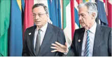  ?? ANDREW HARRER/BLOOMBERG ?? ECB president Mario Draghi walks with U.S. Fed chair Jerome Powell. While the Fed has signalled it will raise interest rates four times this year to keep pace with a U.S. economy currently growing at an annualized pace of 4.5%, the ECB signalled last...