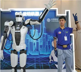  ?? Photo: Xinhua ?? A robot capable of simulating human movements using a 5G network is displayed at the opening of the Jiangxi Internatio­nal Mobile Internet of Things Expo in Yingtan, Jiangxi province .