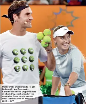  ??  ?? Melbourne: Switzerlan­d's Roger Federer (C) and Denmark's Caroline Wozniacki (R) participat­e in a Kids Day event ahead of the Australian Open tennis tournament in Melbourne on January 13, 2018. -- AFP