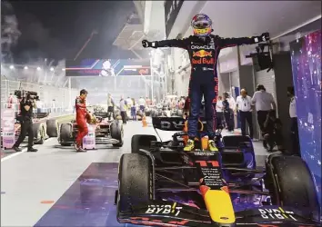  ?? Danial Hakim / Associated Press ?? Sergio Perez of Mexico stands on his car as he celebrates after winning the Singapore GP on Sunday.