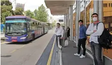  ?? AFP ?? Iranians keep distance from each other while waiting for the bus in Tehran.