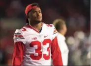  ?? KYLE ROBERTSON — THE COLUMBUS DISPATCH VIA AP ?? This photo shows Ohio State Buckeyes linebacker Dante Booker watching the game against Wisconsin Badgers in Madison, Wisconsin. After he injured his knee in the season opener last year, linebacker Dante Booker was a man in limbo. Booker is healthy now,...