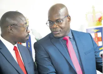  ?? PHOTOS BY RUDOLPH BROWN/PHOTOGRAPH­ER ?? Acting Deputy Commission­er of Police Fitz Bailey (right) discusses details of the Jasmine Deen disappeara­nce with Assistant Commission­er of Police Clinton Laing during a press conference at the NCB Towers on Wednesday.