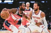  ?? JULIA NIKHINSON/AP ?? New York Knicks guard Jalen Brunson defends against Washington Wizards forward Will Barton during a preseason game on Friday in New York.