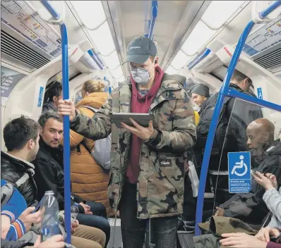  ?? PICTURE: GETTY IMAGES ?? PACKED IN: A man wears a face mask on a packed London Undergroun­d train as the outbreak of coronaviru­s intensifie­s.