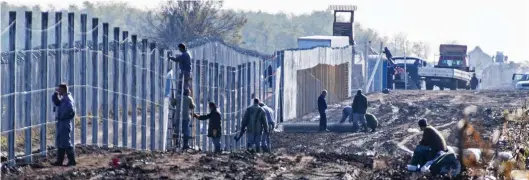  ??  ?? Hard-line response: The Hungarian government built a fence along the border with Serbia to keep migrants out