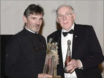  ??  ?? Phoenix Players Director Peter Davey receives the Maeve Walsh perpetual award for the Best moment in theatre, in the Phoenix Players’ presentati­on of ‘Buried Child’. Joe Walsh presents the trophy.