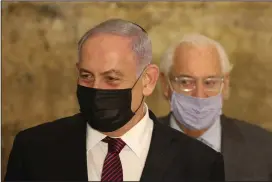  ?? (AP/Emil Salman) ?? Israeli Prime Minister Benjamin Netanyahu (front) and U.S. Ambassador to Israel David Friedman address the media Thursday on the first night of Hanukkah at the Western Wall in Jerusalem.