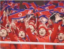  ?? AFPPIX ?? Cheerleade­rs wave North Korean flags as they attend the pair skating short programme at the Gangneung Ice Arena during the Winter Olympics on Feb 14.