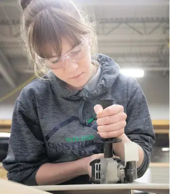  ?? DAX MELMER ?? Local constructi­on and labour officials are working more closely with educators in a bid to train people to fill tomorrow’s jobs. Over the past couple of years, teens like Grade 11 student Maggie MacDonald have learned constructi­on skills in a unique program based out of St. Joseph’s Catholic High School.