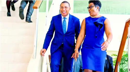  ??  ?? Prime Minister Andrew Holness is escorted to the conference room by M. Gibson Henlin, QC, for the Women in Law Conference 2019, held at The UWI Regional Headquarte­rs in Kingston on Internatio­nal Women’s Day last Friday.