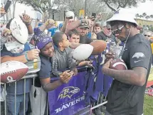  ??  ?? Baltimore quarterbac­k Lamar Jackson signs autographs during a practice for the Pro Bowl on Thursday in Kissimmee, Fla.