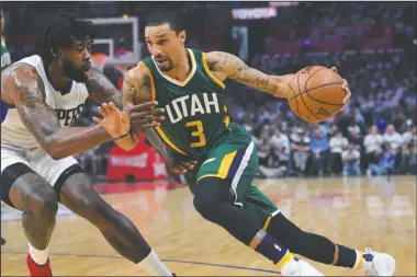  ?? The Associated Press ?? SMOOTH SAILING: Utah Jazz guard George Hill, right, drives past Los Angeles Clippers center DeAndre Jordan during the first half in Game 7 of an NBA first-round playoff series Sunday in Los Angeles. The Jazz won the series, 4-3, in the only first round...