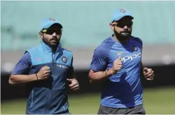  ??  ?? LONDON: India’s captain Virat Kohli, right, runs with India’s Ajinkya Rahane during a training session at the Oval cricket ground in London, yesterday. India are due to play Pakistan in the ICC Trophy final cricket match at the Oval today. —AP
