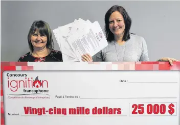  ?? SUBMITTED PHOTO ?? Velma Robichaud, left, coordinato­r of the new Francophon­e Ignition Contest, shows the entry forms of the eight contestant­s. On March 16, one of these eight names will be written on this big $25,000 cheque being held with Robichaud by RDÉE PEI executive director Bonnie Gallant.