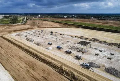  ?? Jay Janner / TNS ?? Federal Reserve Bank of Dallas surveys show Texas’ key sectors continue to grow despite pandemic and supply chain issues. Above, work continues at the Tesla factory site near Austin, with limited vehicle deliveries expected to start next year.