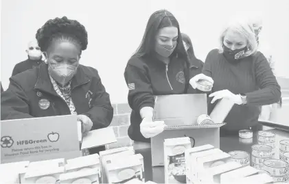  ?? ELIZABETH CONLEY/HOUSTON CHRONICLE ?? Democratic Reps. Sheila Jackson Lee, of Texas, left, Alexandria Ocasio-Cortez, of New York, and Sylvia Garcia, of Texas, distribute food Saturday at the Houston Food Bank in Texas, which is recovering from extreme weather.