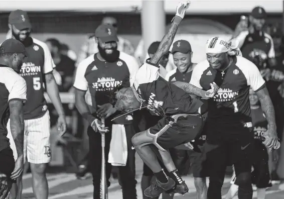  ?? Photos by Godofredo A. Vasquez / Staff photograph­er ?? Houston rapper Travis Scott celebrates his home run during James Harden’s celebrity softball game Saturday at the University of Houston.