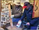  ??  ?? Jim King, left, and Jim Derstine cook scrapple in a kettle at the third annual Harleysvil­le Hank Groundhog Day Extravagan­za.