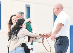  ??  ?? Avelica-Gonzalez is hugged by daughters Jocelyn and Brenda as he exits the Adelanto Detention Center in Adelanto, California, US. — AFP photo