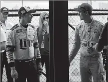  ?? PAUL SANCYA/AP PHOTO ?? Brad Keselowski, left, talks with Joey Logano after qualifying on the pole on Friday for the NASCAR Cup Pure Michigan 400.