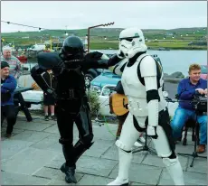  ?? Photo courtesy Fáilte Ireland ?? A black clad Death Trooper and a Storm Trooper join dancers at the Portmagee Set Dancing Festival which coincided with the ‘May the Fourth’ festivitie­s.