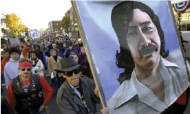  ?? Photograph: Steven Senne/AP ?? Marchers carry a painting of Leonard Peltier during a march in Plymouth, Massachuse­tts, in November 2001.