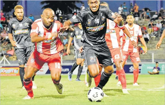  ?? Picture: SOPHIE RALULU ?? Ba player Etonia Dogolau (right) wins the ball from Labasa’s Christophe­r Wasasala during the Courts Inter Distrcit Competitio­n at the HFC Bank Stadium in Suva yesterday.