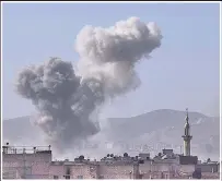  ??  ?? DEATHLY PALL Smoke rises above Douma after attack