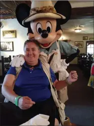  ?? PHOTO PROVIDED ?? Local business owner Colleen Parisi of A Walk in the Park with Colleen visits with Mickey Mouse at Walt Disney World in Orlando, Fla.