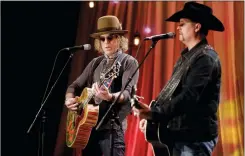  ?? AP PHOTO/MARK HUMPHREY, FILE ?? Kenny Alphin, left, and John Rich, right, of the country music duo Big & Rich, perform a song during a taping for Dolly Parton's Smoky Mountain Rise Telethon in Nashville, Tenn., in December. The mass shooting at a country music festival on Oct. 1,...