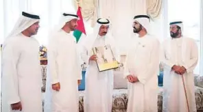  ??  ?? WAM Shaikh Mohammad Bin Rashid and Shaikh Mohammad Bin Zayed receive the book titled Umm Kulthum in Abu Dhabi from Mohammad Al Murr.