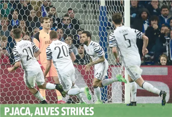  ?? — AFP ?? Juventus’ Brazilian defender Dani Alves (2R) celebrates after scoring a goal during the Uefa Champions League round of 16 second leg match against FC Porto at the Dragao stadium in Porto.